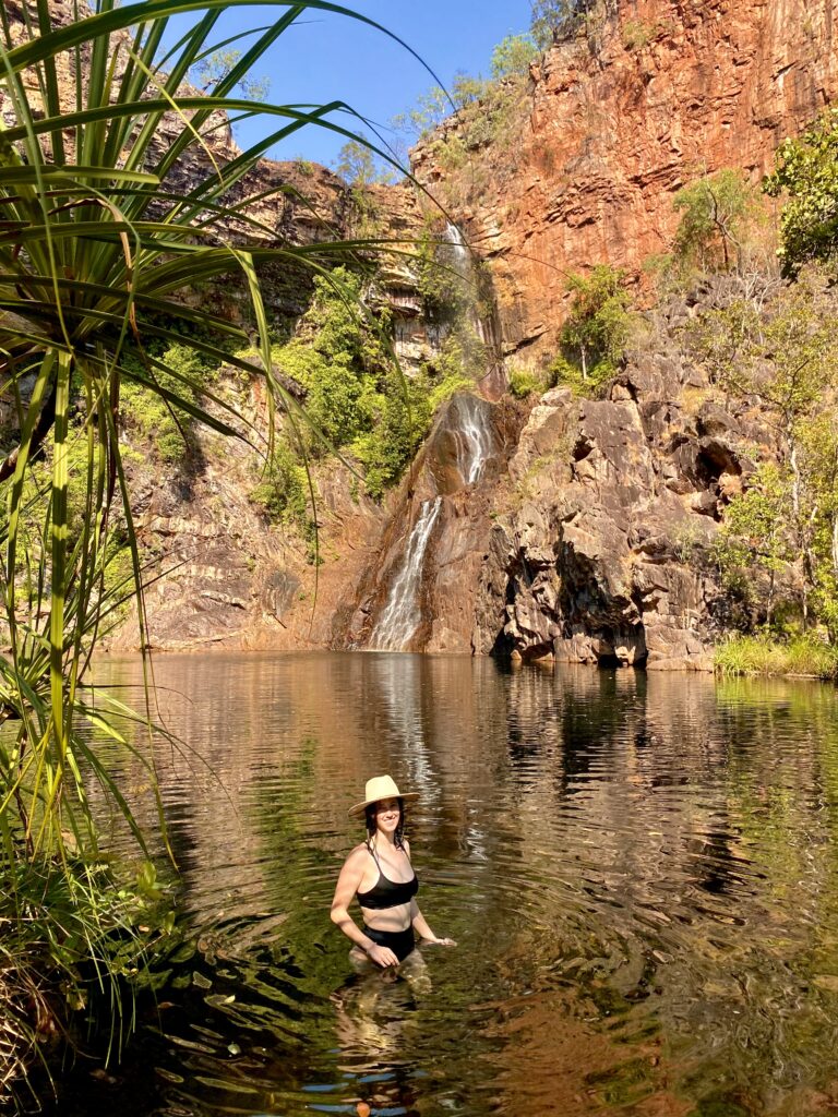 Woman in black bikini swimming in Sandy Creek Tjaynera Falls in Litchfield National Park, Litchy