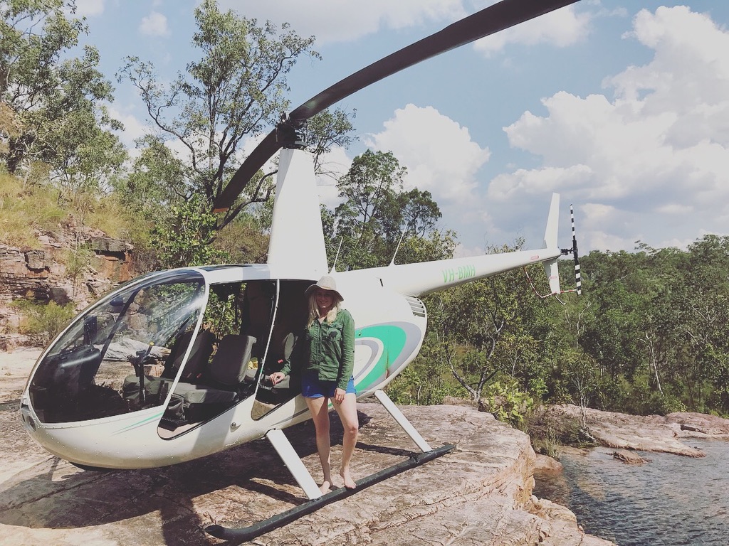 woman standing in front of helicopter in litchfield national park